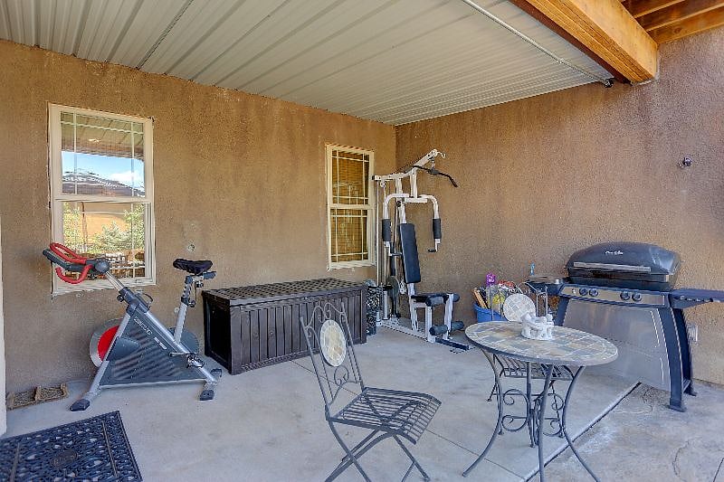 Covered Patio with Gas Grill, Weight Machine and Stationary Bike