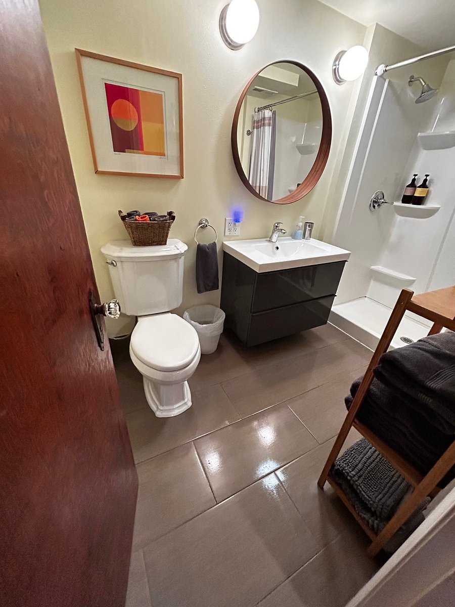 Large Bath with 2 drawer vanity, bamboo shelves, towels.