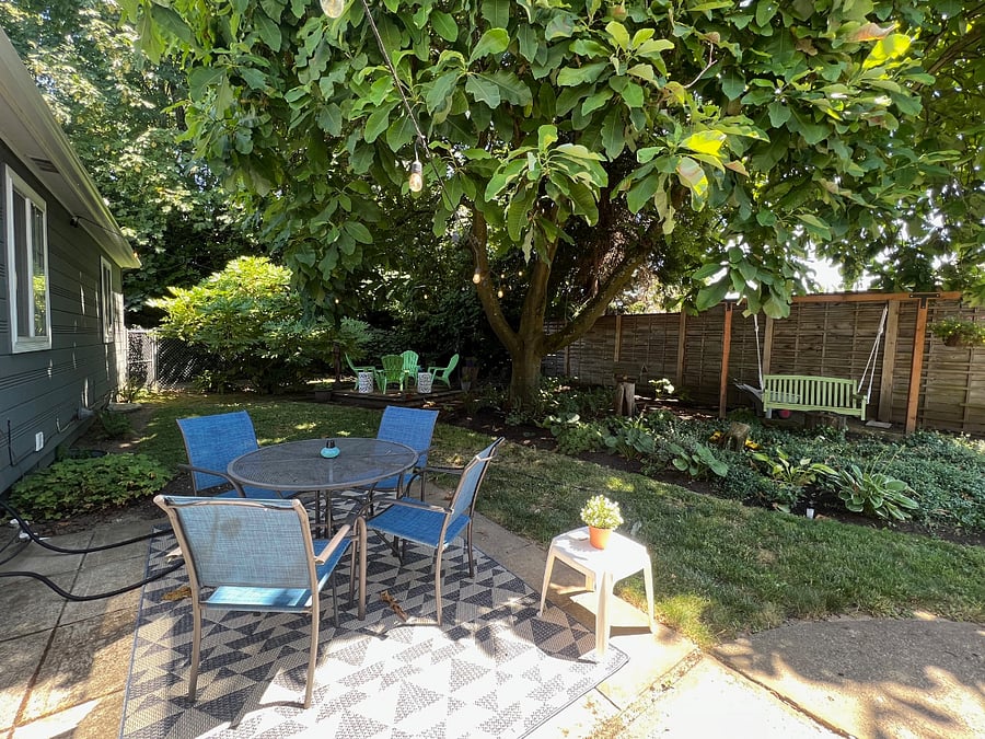 Back patio with table, 4 chairs and Weber BBQ, all fenced in for privacy