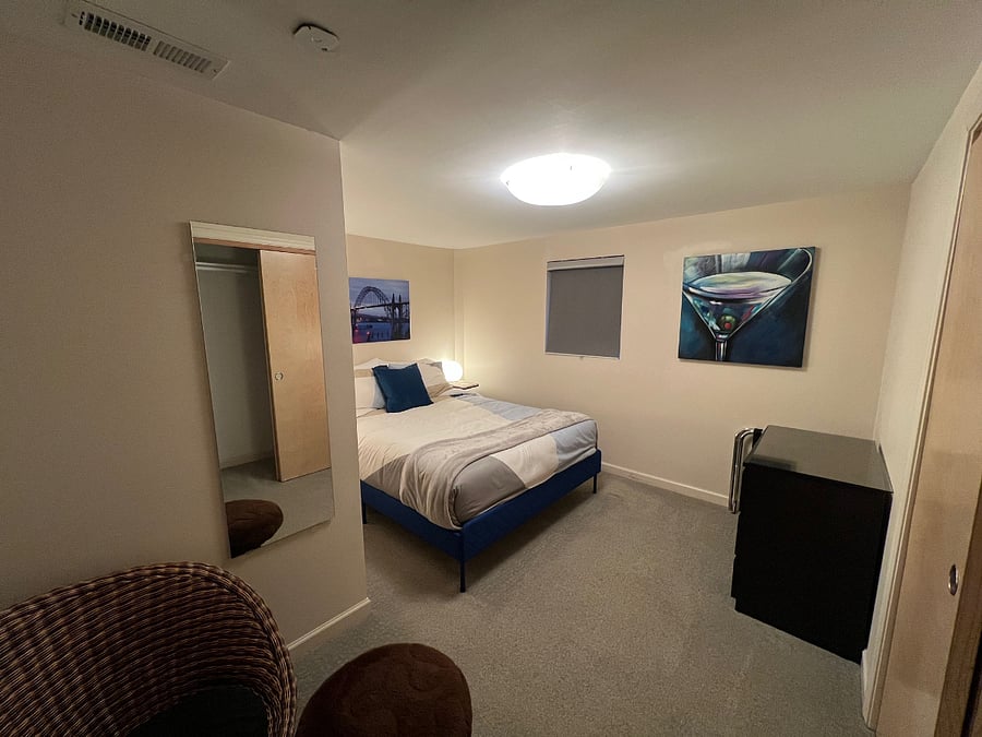 Guest Bedroom with sitting chair, closet and dresser