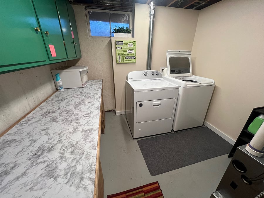 Full size laundry room with iron, iron board, broom, vacuum