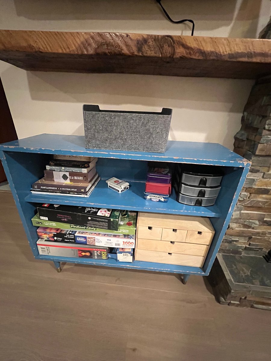 Vintage book shelf with card, games, books and puzzles.