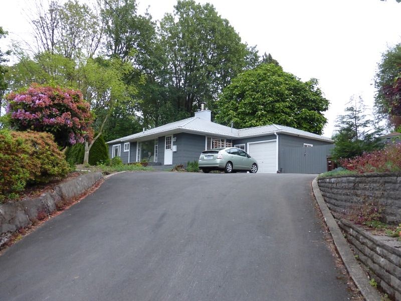 House sits uphill above the neighborhood and extra wide driveway for off street parking