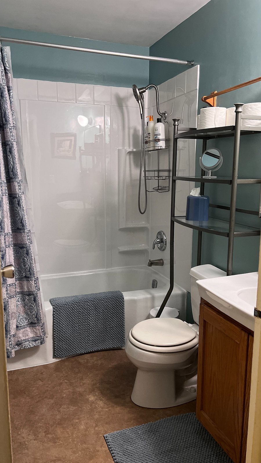 Freshly painted bathroom with new tub surround and plumbing fixtures.