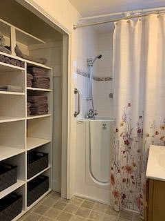 Bathroom with walk in tub/shower combination.