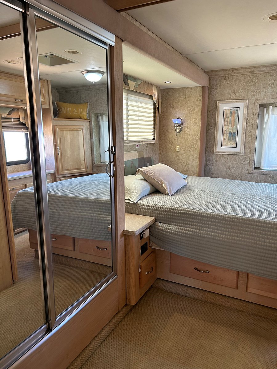 Sliding mirror closet doors in hallway to bedroom