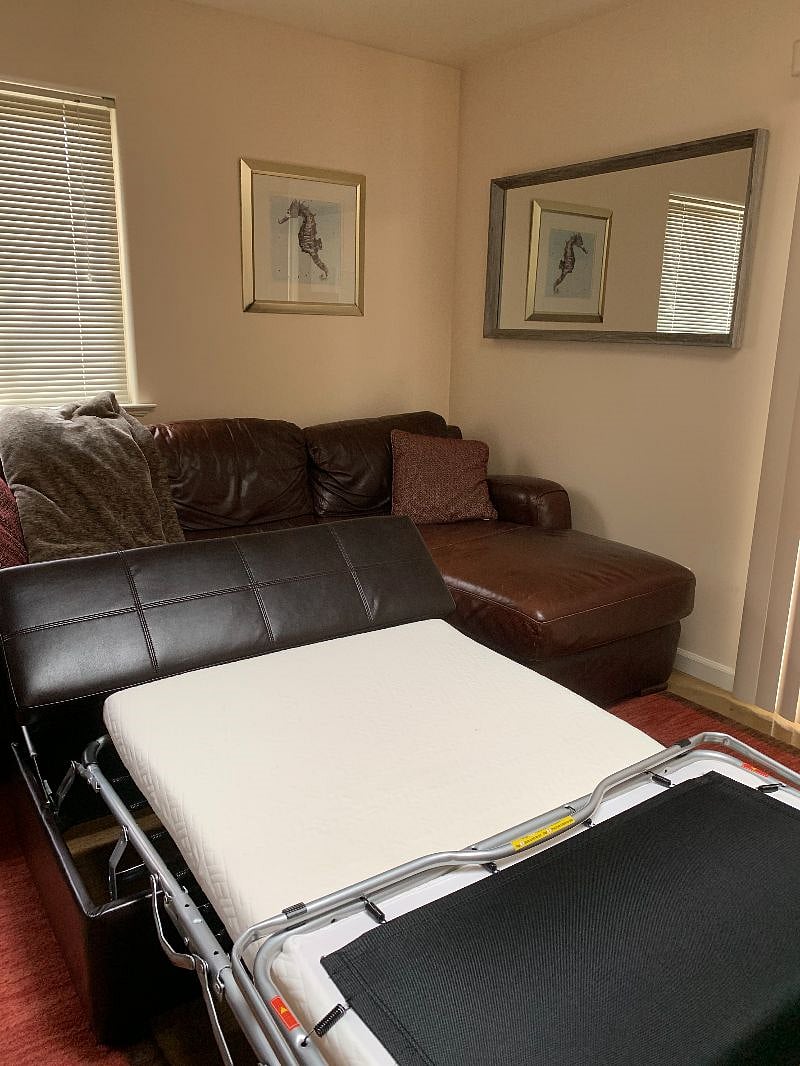 Foot rest pulling out to a bed. The bed has a very comfortable tempur-pedic mattress.