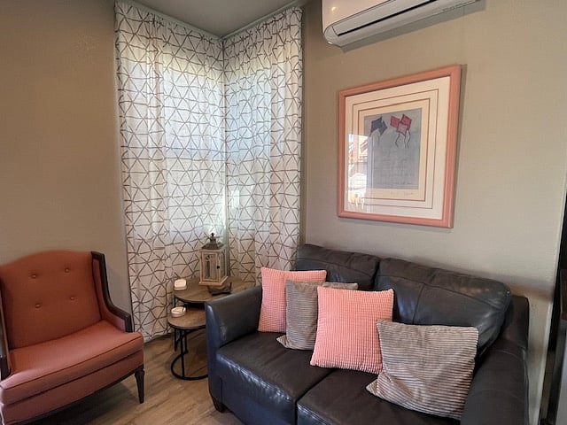 Living room with leather loveseat and additional seating