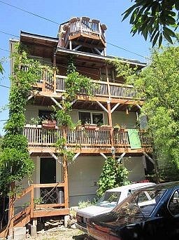 Rear balconies with wisteria vines.   