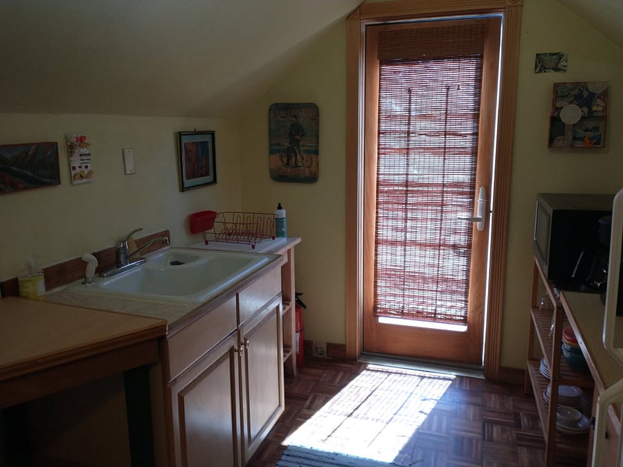 Kitchen sink and door to small balcony.