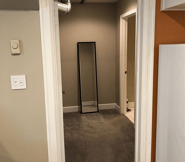 Hallway to bathroom. Room for clothing rack and more storage