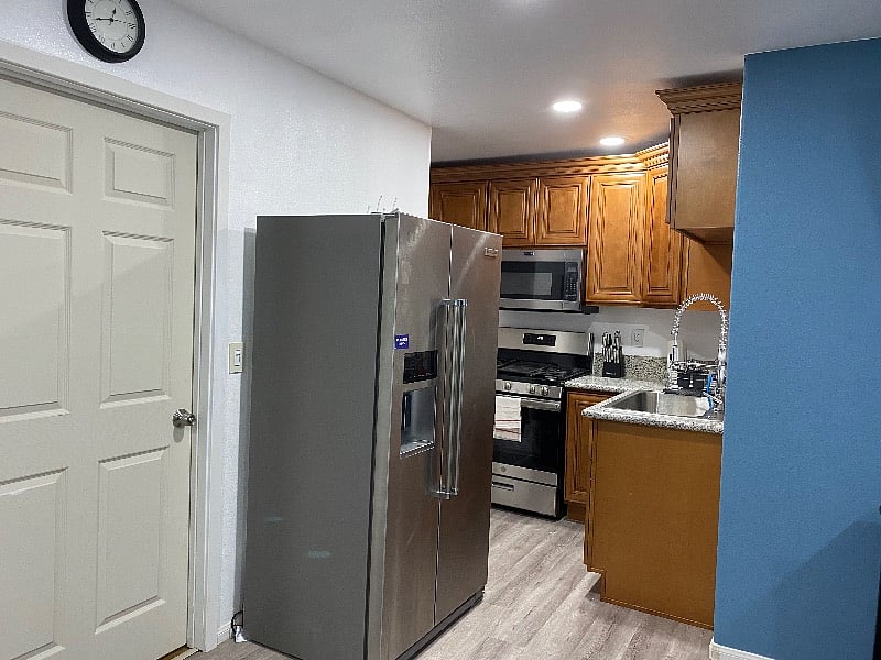 Cabinet for storage, new stove, microwave, fridge, and marble countertops