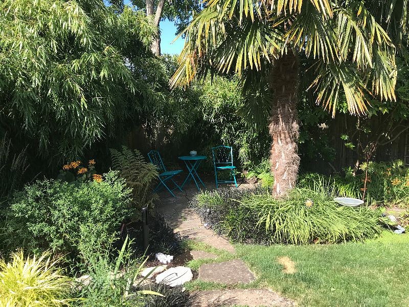 Secluded garden nook in shared backyard