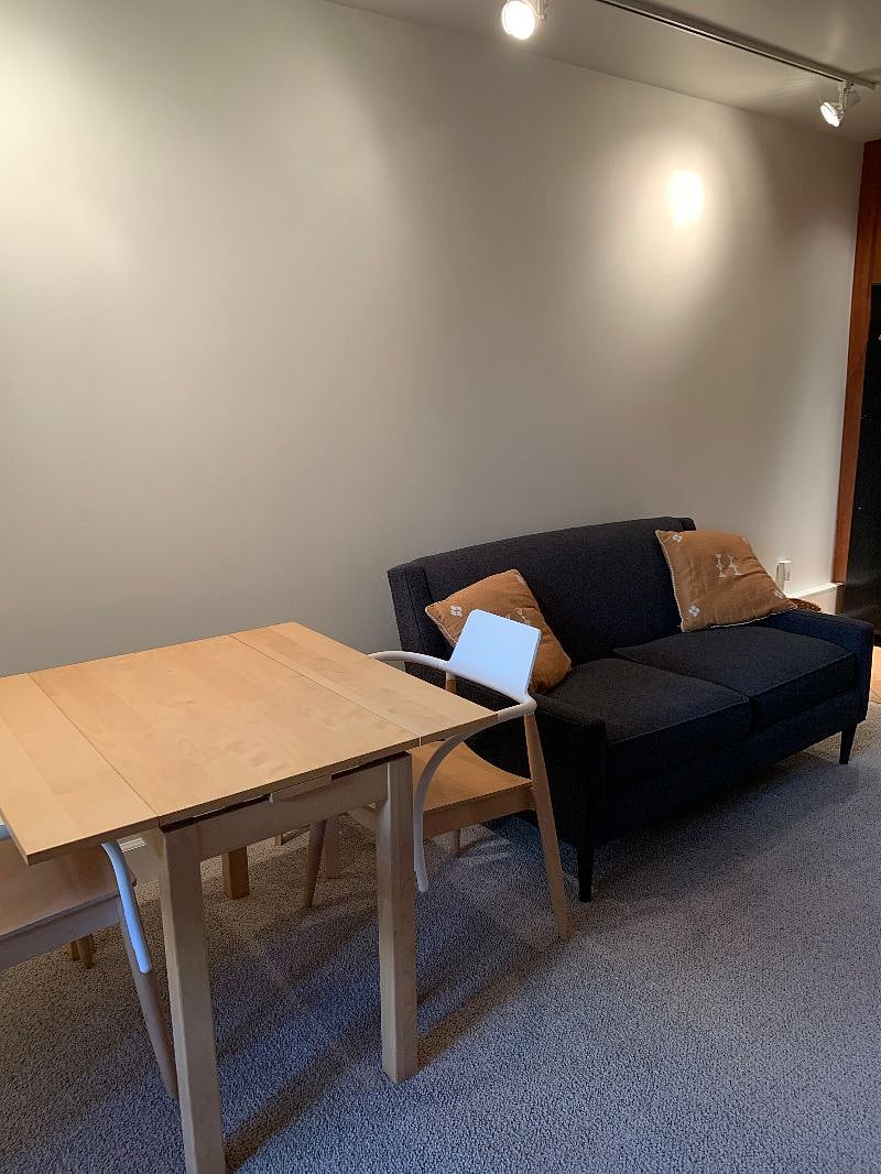 Table and couch, between kitchen and sliding door into back yard