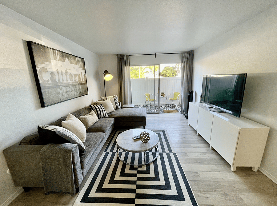 Living room with patio off it and roku TV