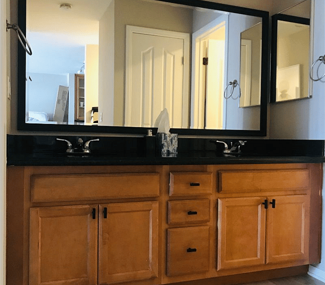 Double vanity off of the bedroom, separate from the shower/bath area. Also has a closet with iron/ironing board and towels across from the vanity.