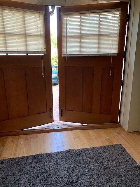 Carriage doors in the cottage open fully for access and to paved patio area.