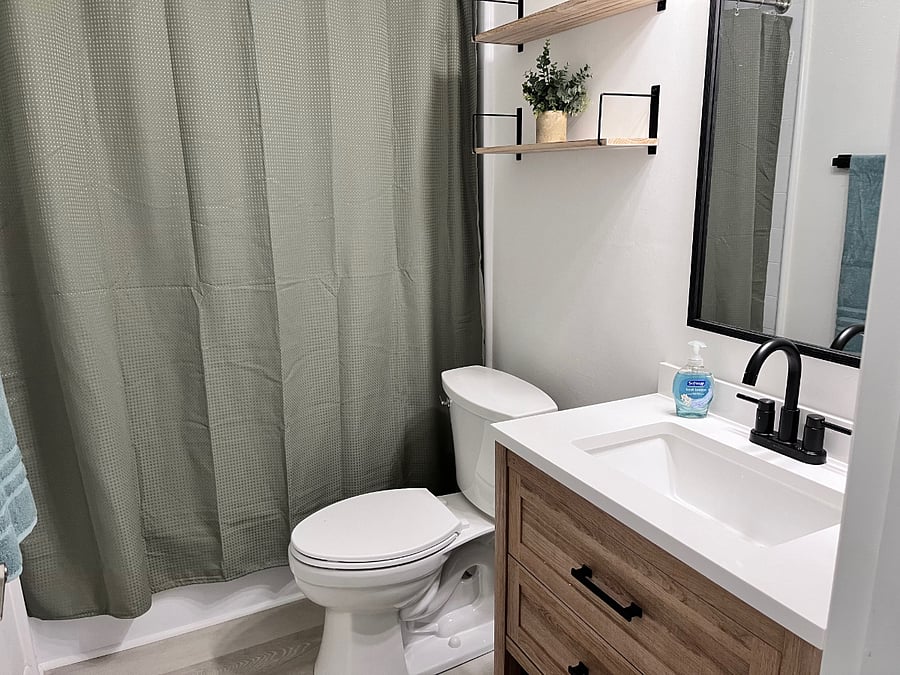 Upstairs bath has storage shelves and drawers, plenty of light, and everything is brand new.