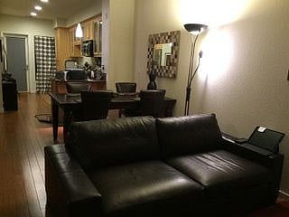 Spacious living room with TV & comfy furnitures