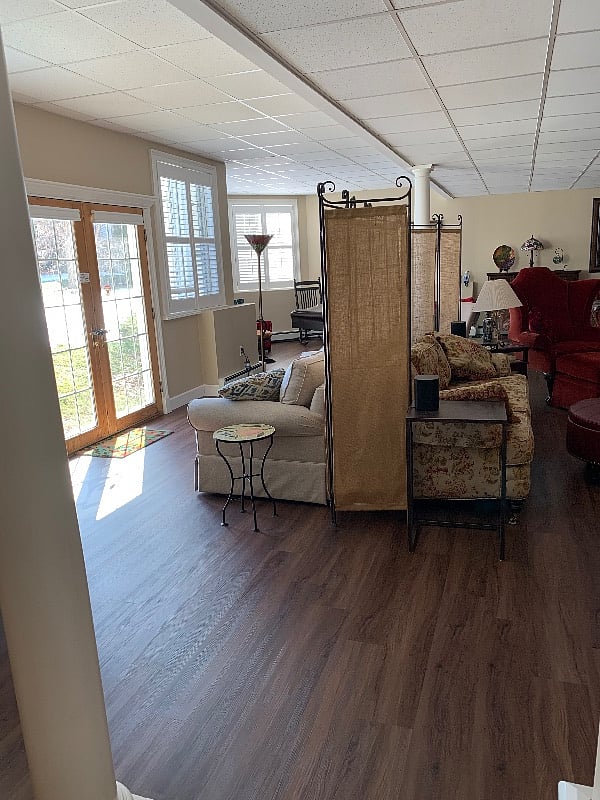 Charming living room with TV, comfy furnitures & emergency exit