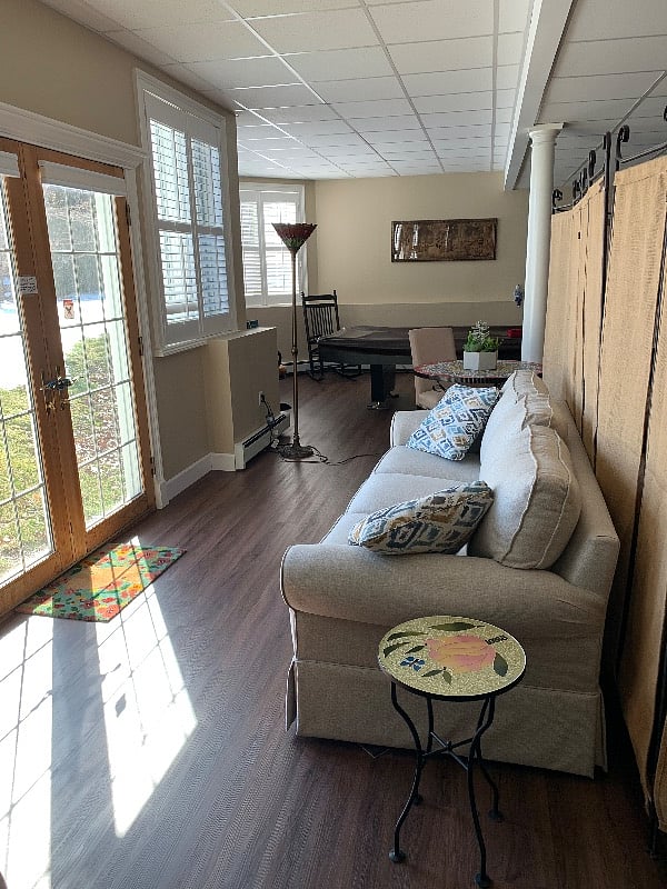 Charming living room with TV, comfy furnitures & emergency exit
