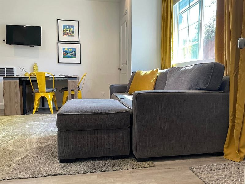 Sofa. Expandable table in background. Wall mounted TV ( I recently updated the T.V. it's larger) Free WiFi