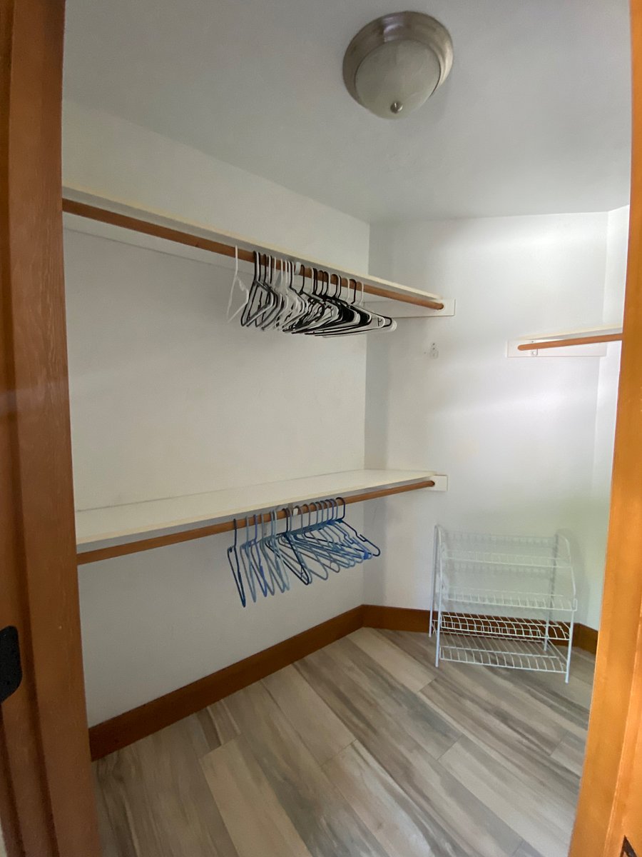 Walk in closet room A with double sided mirrored door
