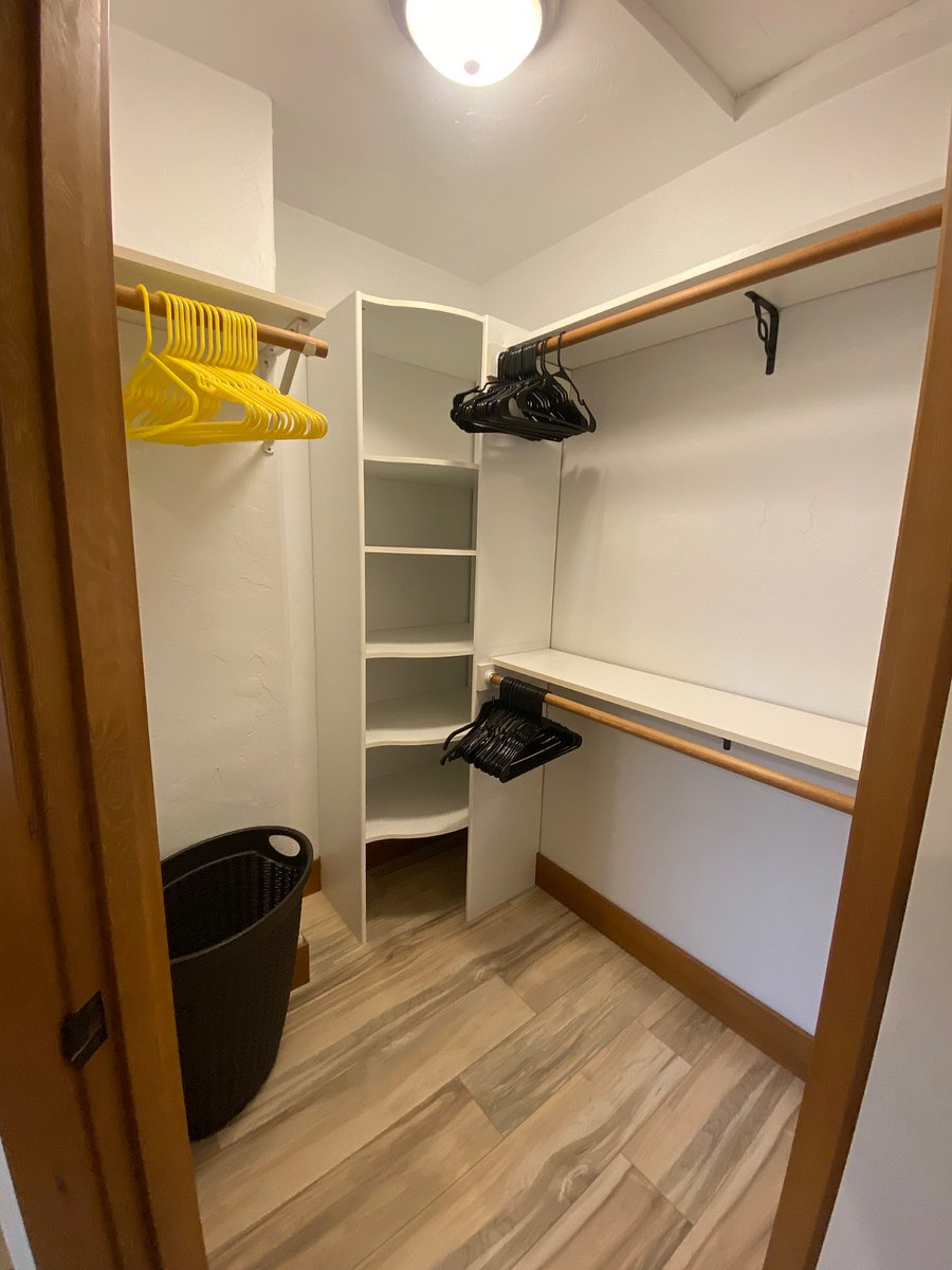 Walk in closet room B. It has a double sided mirrored door