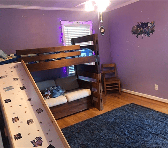 Childs bedroom with twin bunk and tv.