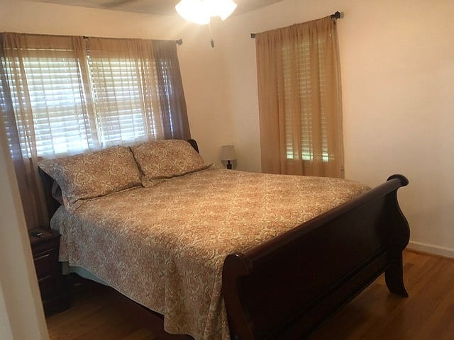 Master Bedroom with queen bed, smart tv and private half bath.