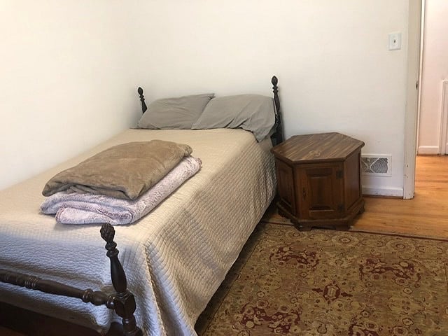 Guest bedroom with queen bed and desk.