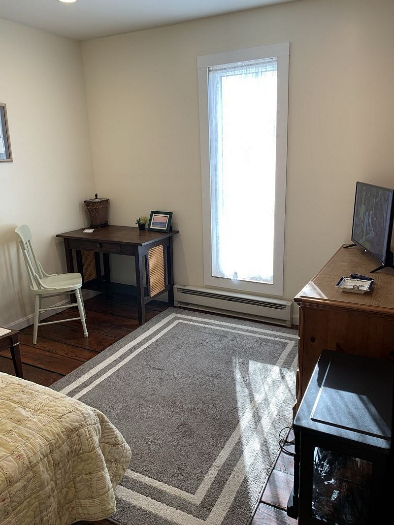 Desk/table and chair in living room.