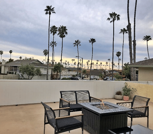 Spacious balcony with sitting area & fire pit