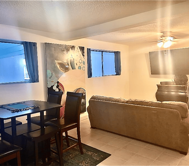Shot from the sliding glass door into the room (flat screen on wall).