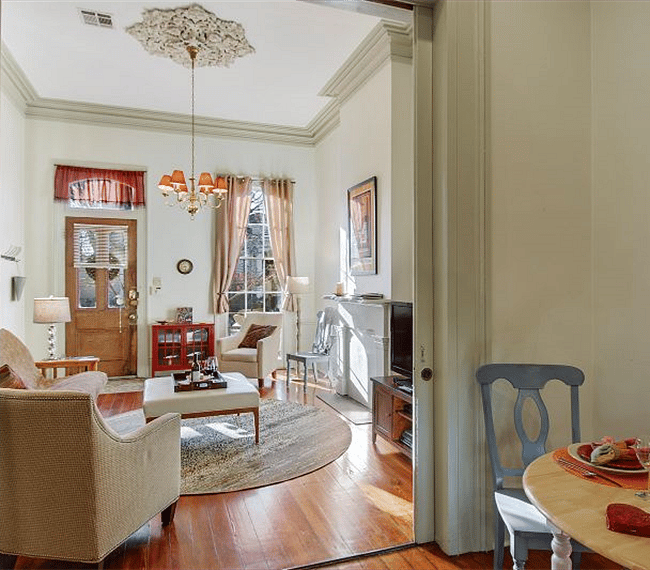 "Front Parlor" Living Room features plaster crown molding & medallion, pocket doors, mantel. Heart-of-Pine flooring throughout
