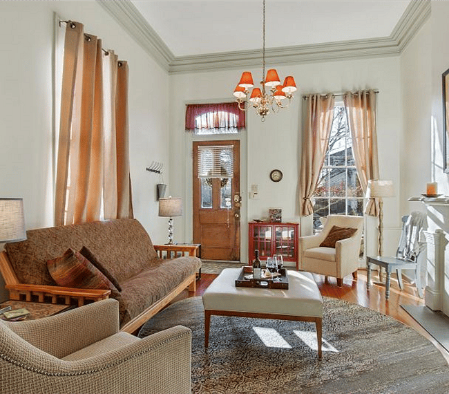 "Front Parlor" Living Room features plaster crown molding & medallion, pocket doors, mantel. Heart-of-Pine flooring throughout
