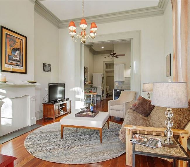 "Front Parlor" Living Room features plaster crown molding & medallion, pocket doors, mantel. Heart-of-Pine flooring throughout