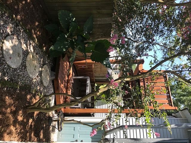Beautiful backyard with crepe myrtles and covered deck.