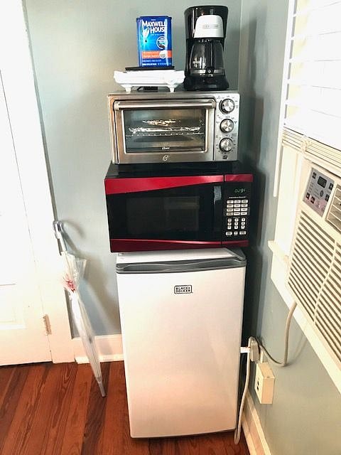 Fridge with small freezer, microwave, toaster oven, coffee maker and hot plate.