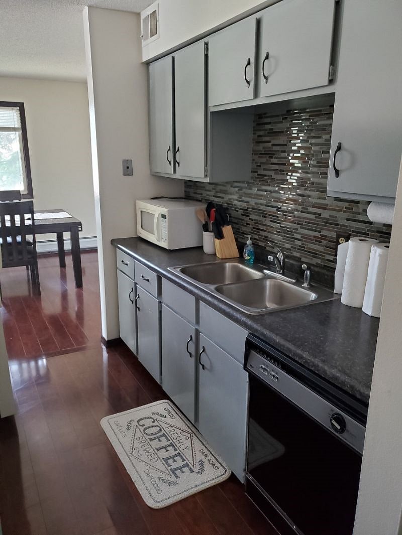 KP101APT1 - Kitchen w/appliances, microwave, dishwasher, cookware/bakeware, place settings, and kitchen essentials, and coffee machine