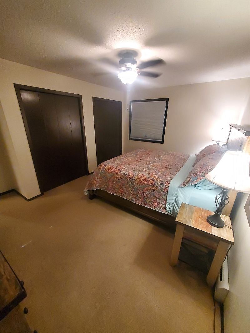 KP101APT1 - Master bedroom w/ king size bed, dresser, mirror, three closets, and ceiling fan