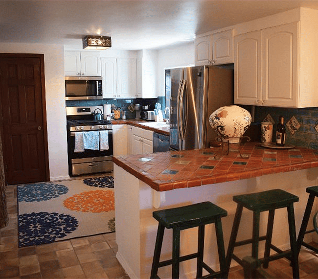 Fully equipped kitchen with all essential implements & counter bar