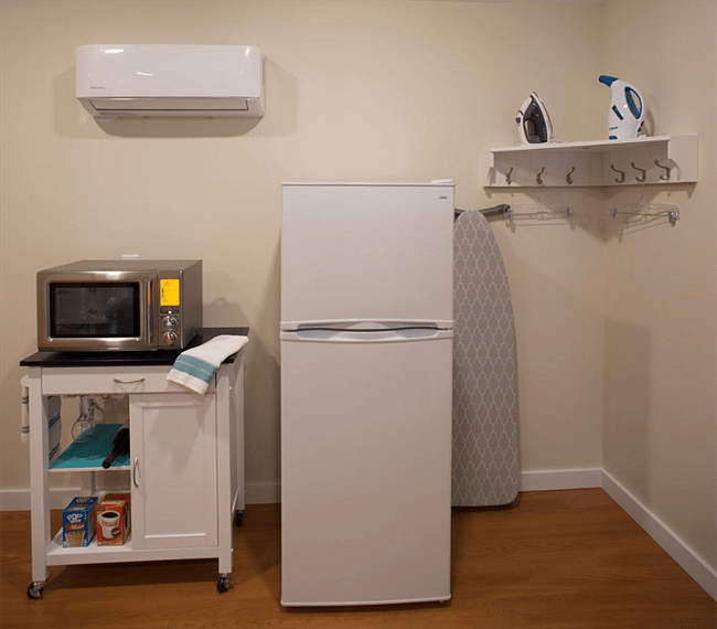Breville Combo is a microwave, convection oven and airfryer. Full size fridge stocked with a few essentials. Corner hanging nook extends closet space.