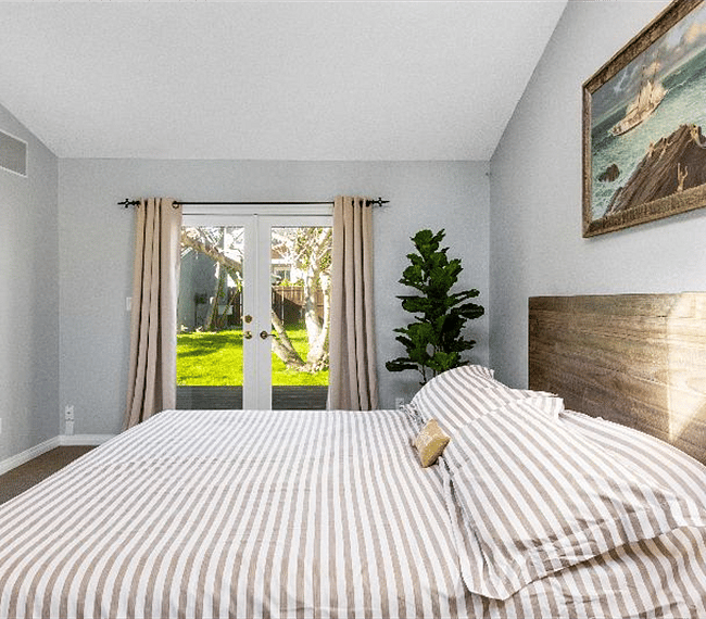 3rd bedroom with retro king size bed, night stand, lamp, wardrobe, beautiful paintings & direct access outdoors