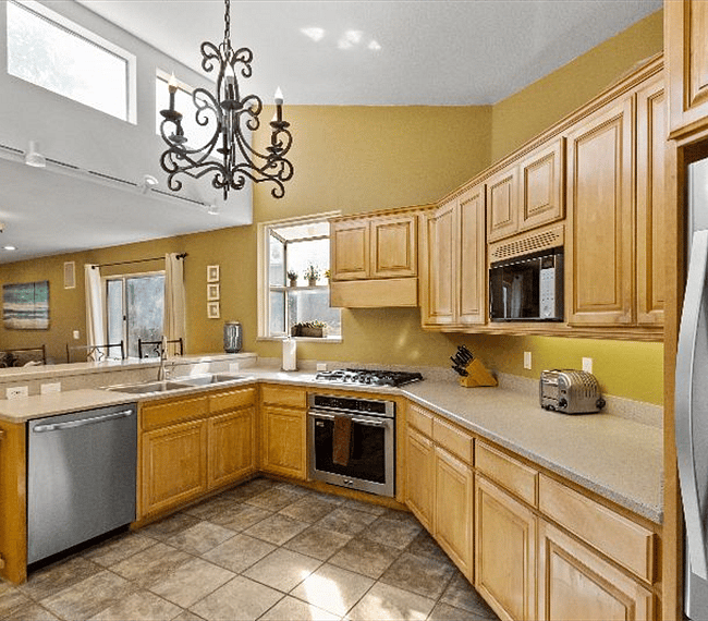 Fully equipped traditional kitchen with wooden shelves and all essential implements included