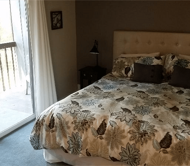 Sliding Door in Bedroom with balcony. Overlooks lovely treed ground.