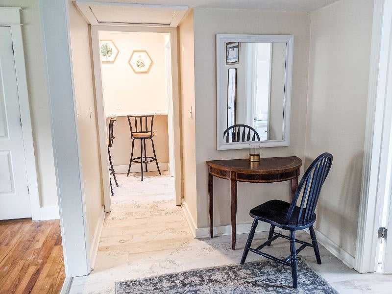 Hallway leads to eat-in nook in kitchen.