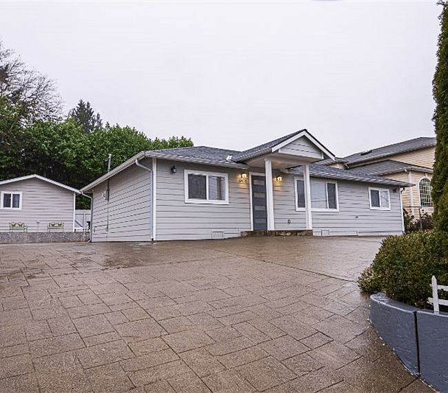 Driveway showing main house with studio to the left.