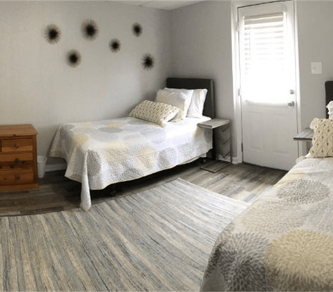 2nd bedroom with comfy twin beds, carpet, drawer, wardrobe & nighstands