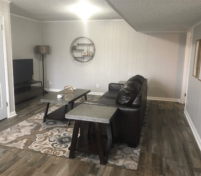 Cozy living room with lawson style sofa, plane table, TV and lovely wall arrangements
